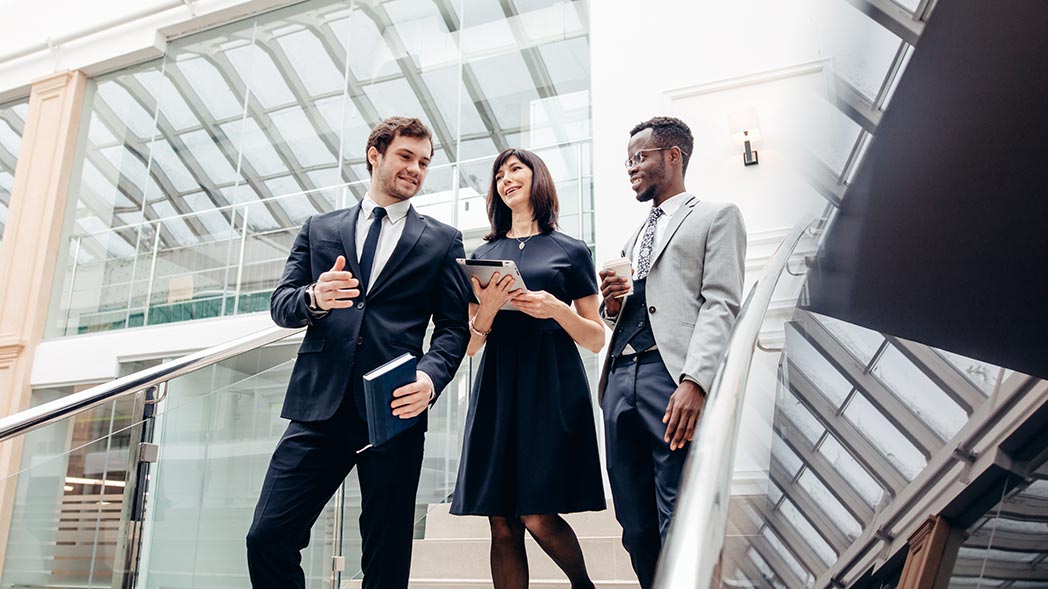 Three colleagues walking on stairs