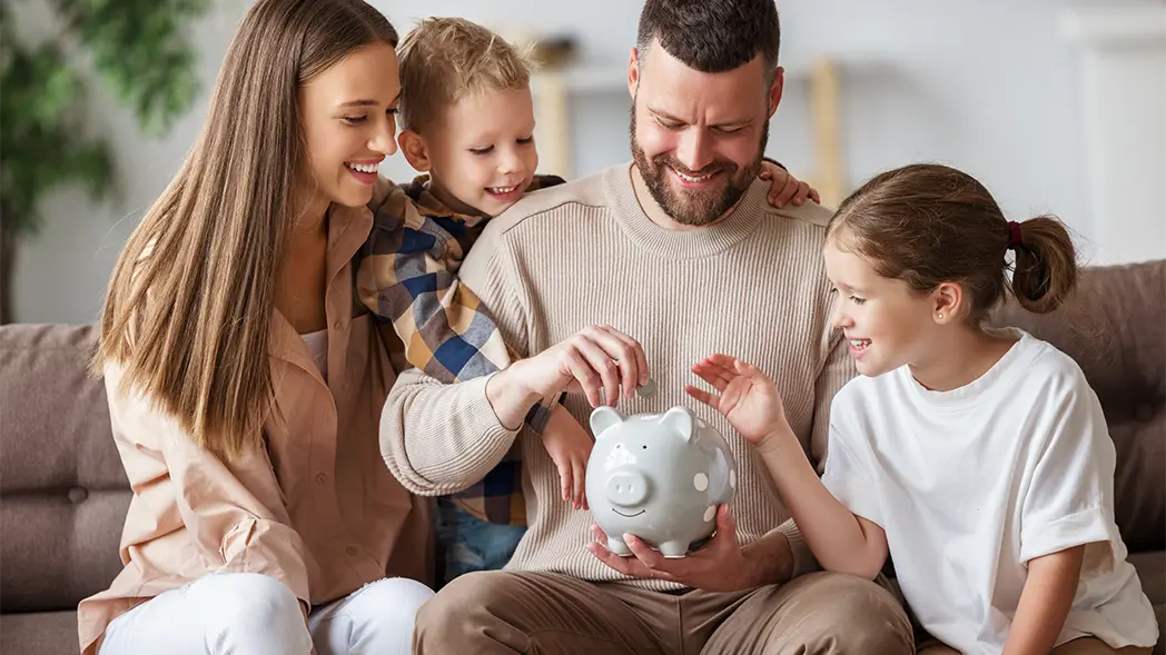 Family throws money into piggy bank